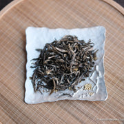 Jasmin green tea Chinese in loose-leaf, scented in high quality processing, on silver tray and bamboo
